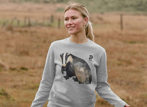 Woman wearing a long sleeve T-Shirt with a badger design